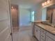 Elegant bathroom with a soaking tub, tiled shower, double vanity, and granite countertop at 13334 Ogden Glade Rd, Dade City, FL 33525