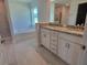 Spacious bathroom featuring a tiled shower, soaking tub, and dual vanity sinks with granite counters at 13334 Ogden Glade Rd, Dade City, FL 33525