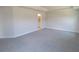 Neutral bedroom with plush carpet, crown molding, and doorway to the ensuite bathroom at 13334 Ogden Glade Rd, Dade City, FL 33525
