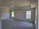 Spacious bedroom with tray ceiling, neutral walls, and ample natural light from two windows at 13334 Ogden Glade Rd, Dade City, FL 33525