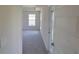 Inviting entryway view into carpeted room with natural light, showcasing a clean, modern design at 13334 Ogden Glade Rd, Dade City, FL 33525