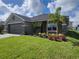 Beautifully landscaped front yard with a well-maintained lawn and charming palm tree at 13334 Ogden Glade Rd, Dade City, FL 33525