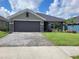 Beautiful single-story home with a landscaped front yard and a spacious two-car garage at 13334 Ogden Glade Rd, Dade City, FL 33525