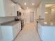 Well-equipped kitchen with stainless steel appliances, granite countertops, and bright white cabinets at 13334 Ogden Glade Rd, Dade City, FL 33525