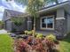 Up close view of the front yard landscaping and charming palm tree at 13334 Ogden Glade Rd, Dade City, FL 33525