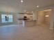 Open floor plan featuring tile flooring, recessed lighting, and a modern kitchen at 13334 Ogden Glade Rd, Dade City, FL 33525