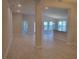 Spacious open-concept living space with neutral tile floors and recessed lighting at 13334 Ogden Glade Rd, Dade City, FL 33525
