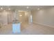 Open-concept living space featuring bright white walls, modern lighting, and tile floors at 13334 Ogden Glade Rd, Dade City, FL 33525