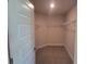 Spacious walk-in closet equipped with wire shelving for optimal storage and organization at 13334 Ogden Glade Rd, Dade City, FL 33525