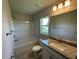 Bathroom featuring granite counters, bathtub and shower combination, and modern fixtures at 13374 Ogden Glade Rd, Dade City, FL 33525