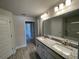 Bathroom featuring double vanity with granite countertop and modern lighting at 13374 Ogden Glade Rd, Dade City, FL 33525