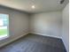 This bedroom has neutral walls, carpet and a window at 13374 Ogden Glade Rd, Dade City, FL 33525