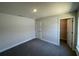A bedroom with neutral carpeting, paint, and a walk-in closet at 13374 Ogden Glade Rd, Dade City, FL 33525
