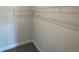 A simple walk-in closet with wire shelving and carpet flooring at 13374 Ogden Glade Rd, Dade City, FL 33525