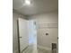 This laundry room features wood-look tile and wire shelving at 13374 Ogden Glade Rd, Dade City, FL 33525
