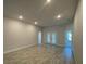 A spacious living area featuring tile flooring, neutral paint, and recessed lighting for a modern touch at 13374 Ogden Glade Rd, Dade City, FL 33525