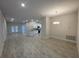 Bright and airy living room with neutral paint, tile flooring, and a view of the kitchen and dining area at 13374 Ogden Glade Rd, Dade City, FL 33525