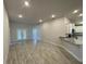 Open-concept living area featuring tile floors, neutral paint, recessed lights and kitchen with granite counter at 13374 Ogden Glade Rd, Dade City, FL 33525