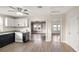 Open kitchen features modern appliances, granite counters, ceiling fan, and light wood flooring at 1513 W Mohawk Ave, Tampa, FL 33603