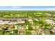 Overhead shot of a residential area with tidy homes and verdant trees, conveniently located near shops and freeways at 1667 E Orangeside Rd, Palm Harbor, FL 34683