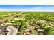 Sweeping aerial image showcasing a neighborhood featuring well-kept residences close to busy city traffic arteries at 1667 E Orangeside Rd, Palm Harbor, FL 34683