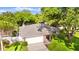 Birds-eye view of house with lush landscaping and an attached garage at 1667 E Orangeside Rd, Palm Harbor, FL 34683