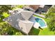 Overhead shot of a house with a backyard pool and well-maintained roof at 1667 E Orangeside Rd, Palm Harbor, FL 34683