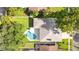 Aerial view of the home's roof and backyard pool and surrounding greenery at 1667 E Orangeside Rd, Palm Harbor, FL 34683