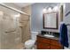 Bathroom offering an updated glass enclosed shower, wood vanity, and modern fixtures at 1667 E Orangeside Rd, Palm Harbor, FL 34683