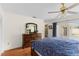 A bright bedroom with a queen bed, dresser, a ceiling fan and private access to outdoor living at 1667 E Orangeside Rd, Palm Harbor, FL 34683