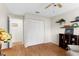 Bright bedroom with a ceiling fan, hardwood floors, and a closet at 1667 E Orangeside Rd, Palm Harbor, FL 34683