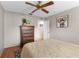 A comfortable bedroom with hardwood floors, ceiling fan, and ample closet space at 1667 E Orangeside Rd, Palm Harbor, FL 34683