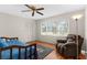 Bedroom featuring a daybed, hardwood floors, and a comfortable recliner at 1667 E Orangeside Rd, Palm Harbor, FL 34683