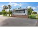 Elegant community sign that reads 'Beacon Groves' near a well-maintained flower bed and palm trees at 1667 E Orangeside Rd, Palm Harbor, FL 34683