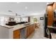Spacious kitchen with granite countertops, stainless steel appliances, and open layout to living area at 1667 E Orangeside Rd, Palm Harbor, FL 34683