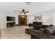 Inviting living room with brick fireplace, ceiling fan, and comfortable seating at 1667 E Orangeside Rd, Palm Harbor, FL 34683
