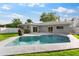 Private backyard featuring a sparkling pool, patio area, and well-maintained landscaping at 1667 E Orangeside Rd, Palm Harbor, FL 34683
