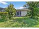 Charming backyard with a lanai and well-maintained lawn, providing an inviting outdoor living space at 1822 Sassafras Dr, Wesley Chapel, FL 33543
