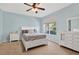 Bright bedroom featuring light blue walls, carpet floors, a ceiling fan, and white furniture at 1822 Sassafras Dr, Wesley Chapel, FL 33543