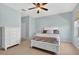 Bright bedroom with neutral walls, ceiling fan and a large dresser for ample storage at 1822 Sassafras Dr, Wesley Chapel, FL 33543