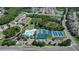 Aerial view showcasing the community pool, tennis courts, playground, and park, offering residents various activities at 1822 Sassafras Dr, Wesley Chapel, FL 33543