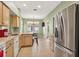 Kitchen featuring stainless steel appliances, wood cabinets, tile flooring, breakfast bar, and dining area at 1822 Sassafras Dr, Wesley Chapel, FL 33543
