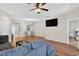 Open living room with hardwood floors, a ceiling fan, and an open layout at 1822 Sassafras Dr, Wesley Chapel, FL 33543