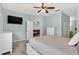 Comfortable main bedroom with a TV, neutral walls, and a doorway to the living area at 1822 Sassafras Dr, Wesley Chapel, FL 33543