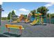 Colorful community playground with slides, climbing structures and seating for a fun outdoor experience at 1822 Sassafras Dr, Wesley Chapel, FL 33543