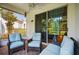 Relaxing screened porch with comfortable seating and sliding glass doors to the interior at 1822 Sassafras Dr, Wesley Chapel, FL 33543