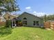 Spacious backyard with lush green grass and mature trees at 18930 Wood Sage Dr, Tampa, FL 33647