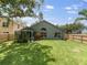 Lush backyard with a greenhouse and mature trees at 18930 Wood Sage Dr, Tampa, FL 33647
