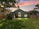 Large backyard featuring a greenhouse and fenced perimeter at 18930 Wood Sage Dr, Tampa, FL 33647