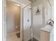 Bathroom showing a clear glass enclosed walk-in shower with white tile and marble countertops at 18930 Wood Sage Dr, Tampa, FL 33647